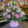 Pink roses and lilies arranged in a pink gift box