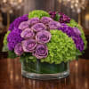 A rich and sophisticated arrangement featuring premium lavender roses, lush green hydrangea