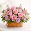 Description: A romantic garden-style arrangement featuring lush pink roses, soft lavender blooms