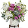 Soft lavender roses and large white lilies create a calm, contemporary statement