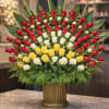 A magnificent large-scale arrangement featuring premium red, white, and yellow roses arranged