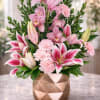 A graceful and sophisticated arrangement featuring premium pink lilies, elegant cymbidium orchids