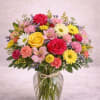  Description: A cheerful hand-tied style arrangement featuring vibrant red and golden