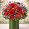 An abundant, garden-style arrangement designed to make a statement. Rich red blooms