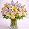  Description: A bright and uplifting arrangement featuring soft yellow lilies, blush