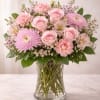 A soft and romantic blend of blush pink roses, delicate carnations, airy