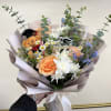Celebrate their achievement with a beautifully crafted graduation bouquet featuring soft peach