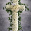A graceful standing cross designed with fresh white carnations and roses, accented