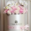A timeless luxury arrangement featuring blush and ivory roses topped with elegant
