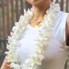 White orchid lei draped around a person wearing a sleeveless top