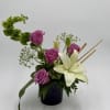 A graceful blend of lavender roses and elegant white lilies creates a