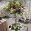 A grand statement arrangement featuring premium blooms designed on an elevated stand