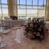 A lush low centerpiece in soft pinks and whites, this wedding reception