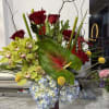 Lush pale blue hydrangeas anchor this Exotic Tropical Beauty arrangement, surrounded by