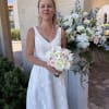 A soft pastel palette of white roses, gardenia, blush spray roses, and