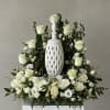 This urn surround design features all white flowers - timeless elegance in