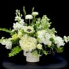 A grand centerpiece with a combination of ranunculus, anemones, hydrangeas, roses, and