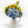 Blue hydrangeas form a lush, rounded mound punctuated by tall, sunny sunflowers-an