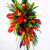 A dramatic, tall tropical standing spray designed for sympathy and memorial services