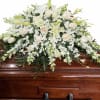 A serene cascade of cream and white roses, white lilies, and delicate
