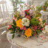 Two sunny yellow roses anchor a fresh, garden-style bouquet that feels like