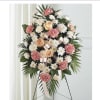 A large standing sympathy spray that reads as quietly elegant and deeply