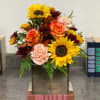A beautiful fall flowers arranged in a wood box is perfect to