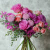 A lush and romantic hand-tied bouquet featuring a vibrant mix of premium