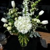 A classic all-white floral tribute offering comfort, serenity and a beautiful expression