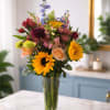 A burst of sunny warmth and sky-blue contrast-this sunflower arrangement is a