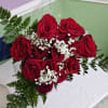 A dense cluster of deep red roses makes an immediate romantic statement-perfect