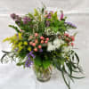 Select this long lasting vase of filler flowers.