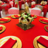 A low, compact centerpiece that reads luxe and celebratory, this flower arrangement
