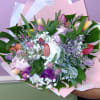 A dense cluster of spring tulips in pink, purple, white, yellow and