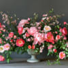 Large pink floral arrangement in a pedestal vase