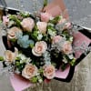 Bouquet of pale pink roses with white filler flowers and silver foliage