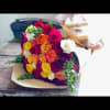 Bouquet of multicolored roses wrapped in tan paper