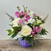 A lavender dimpled cube with Stock, Roses, Daisies, Aster, lemon and leather