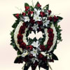 A circular sympathy wreath shaped in formal red and white makes a