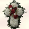 A dignified sympathy cross crafted from dense clusters of white chrysanthemums with