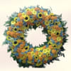 A bright, thoughtfully composed memorial wreath that says "I'm thinking of you"