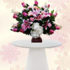 Soft pink lilies and roses take center stage in this romantic flower
