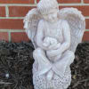 Beautiful statue of a boy angel holding a puppy