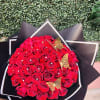 50 red roses (wrapped in paper)