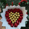 18 RED ROSES AROUND A CHOCOLATE SHAPED HEART WRAPPED IN PAPER