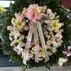 Medium Pink &amp; white Sympathy wreath
includes Roses, carnations, lilies, daisies and filler