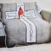 Quilted memorial pillow shaped like a cross with a red cardinal and text.