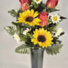 Bright yellow sunflower blooms paired with deep red rose buds create a