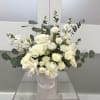 A lush cluster of creamy white roses and delicate lisianthus arranged in