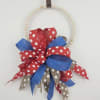 A bold ribbon-adorned hanging ring that reads as festive home decor-perfect for
